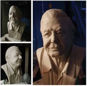 Anil working on a detailed clay portrait bust of Sir David Attenborough in his studio