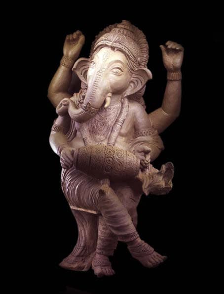 Ornately sculpted Ganapathi figure finished in vibrant details inside a temple structure
